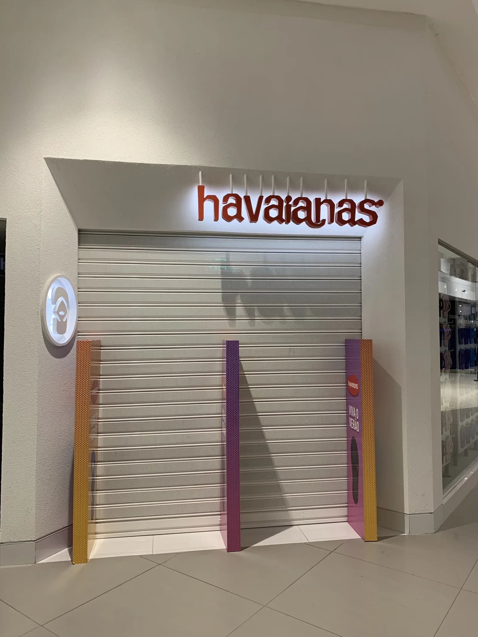 Grade de enrolar cega clara, fechada, numa loja Havaianas num centro comercial — Grupo KEFE, Luanda.