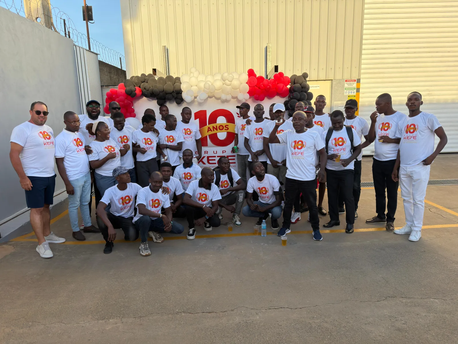 Equipa do Grupo KEFE reunida na celebração dos 10 anos da empresa, com t-shirts comemorativas — Luanda.